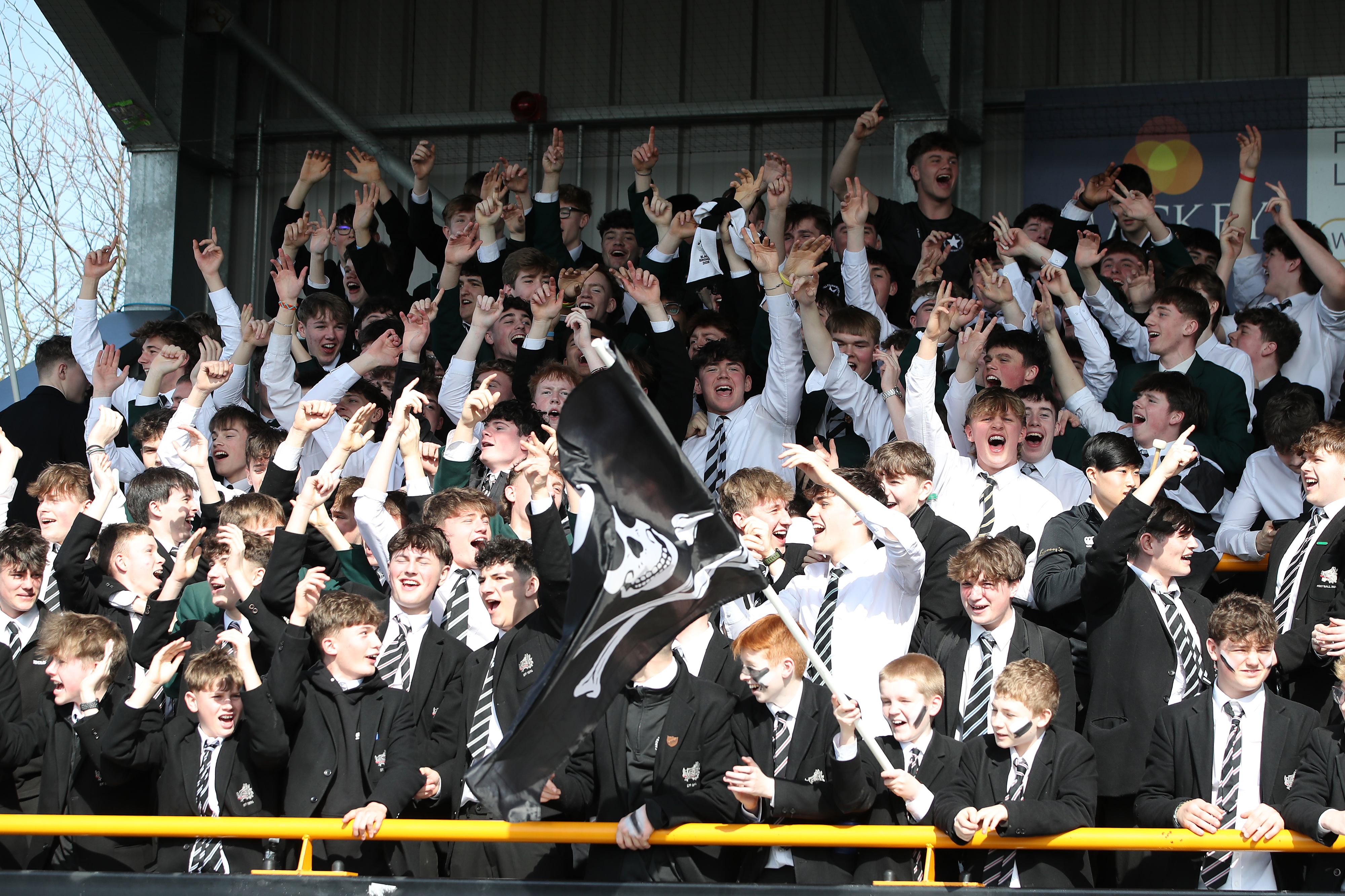 School pupils cheering from the stand